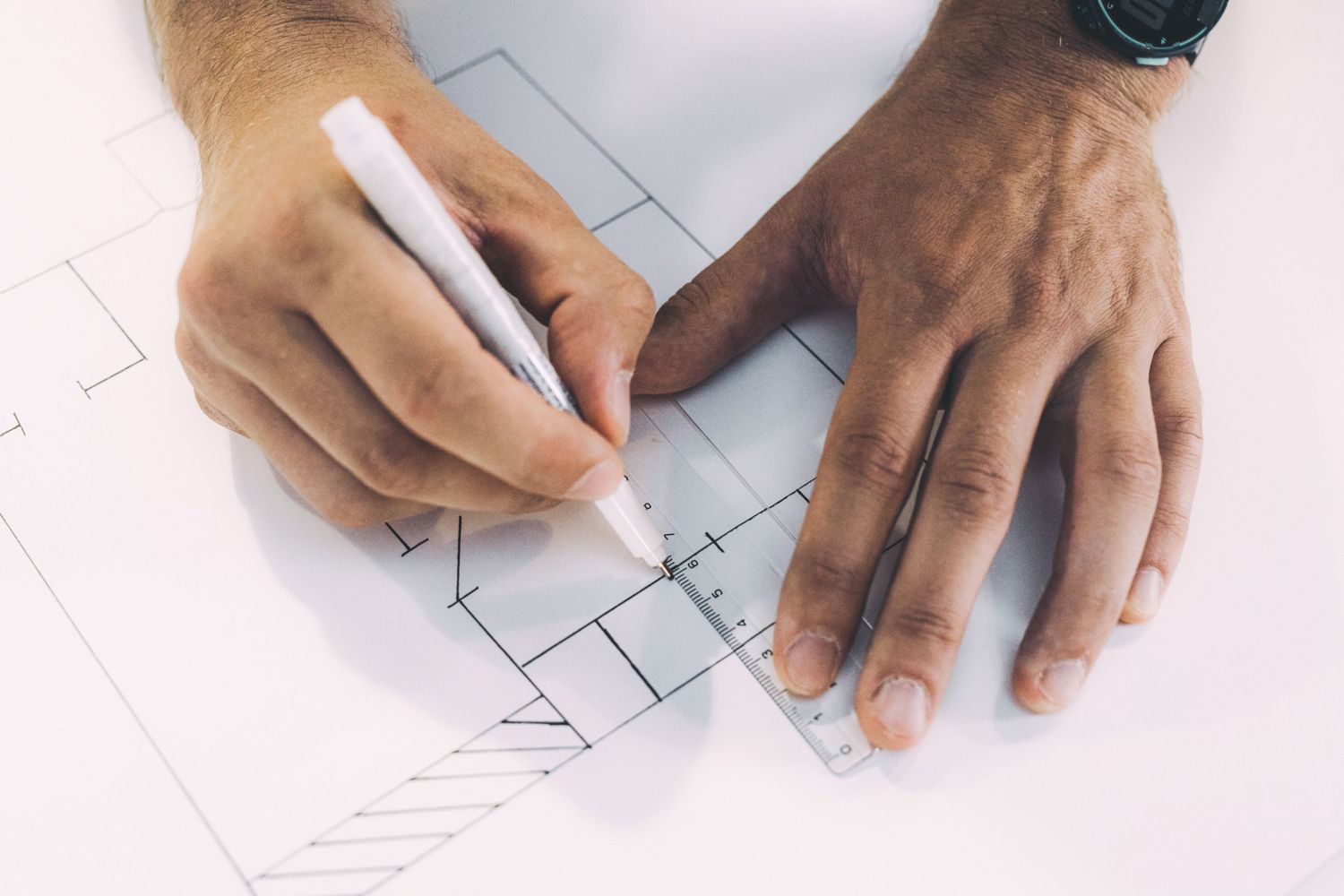 Hand drawing a floor plan with a pen