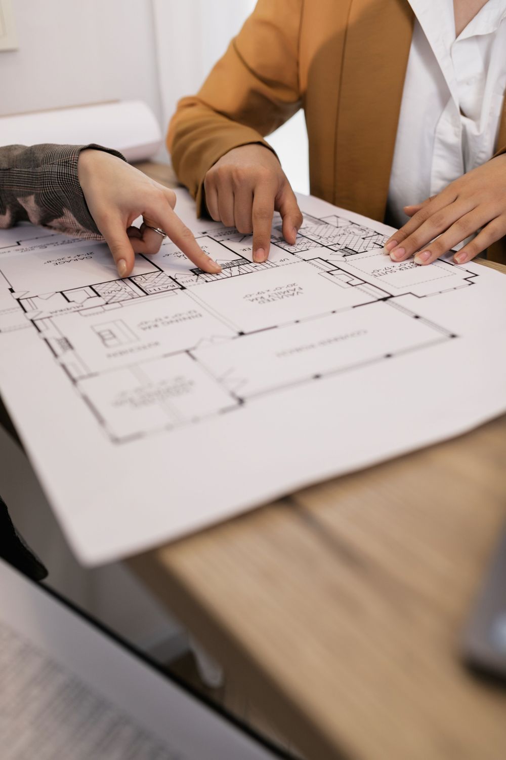 Two people reviewing a printed floor plan